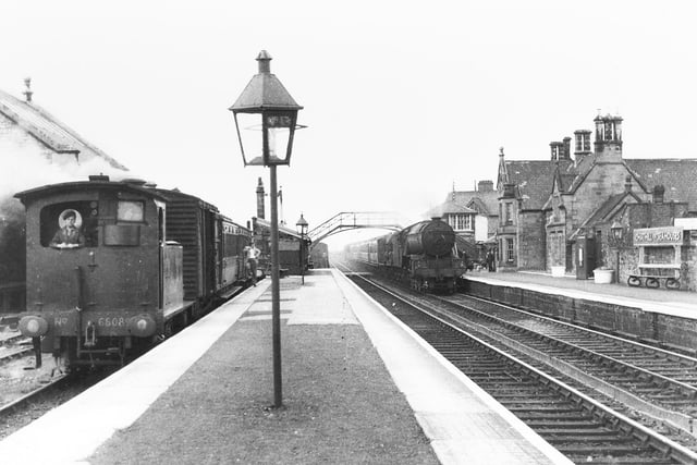 Y7 class 0-4-0T no. 68089 and driver wait at Chathill to leave for Seahouses. Possibly there may be passengers from the train hauled by a class V2 2-6-2 entering the station. Notice the full station name board. (W.A.Camwell)