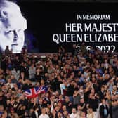 An LED board at the London Stadium shows a photo Queen Elizabeth II as players observe a minutes silence before a Europa League fixture last week.