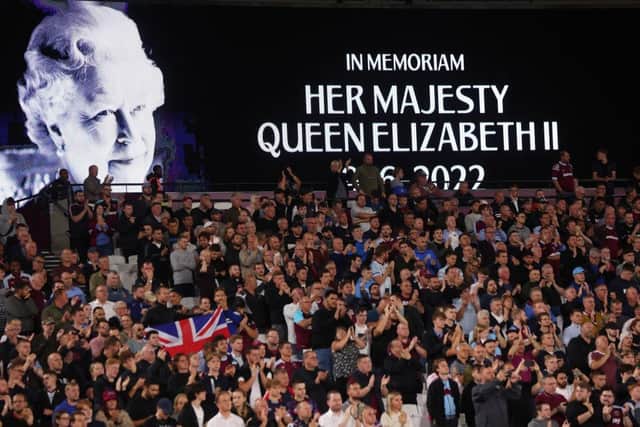 An LED board at the London Stadium shows a photo Queen Elizabeth II as players observe a minutes silence before a Europa League fixture last week.