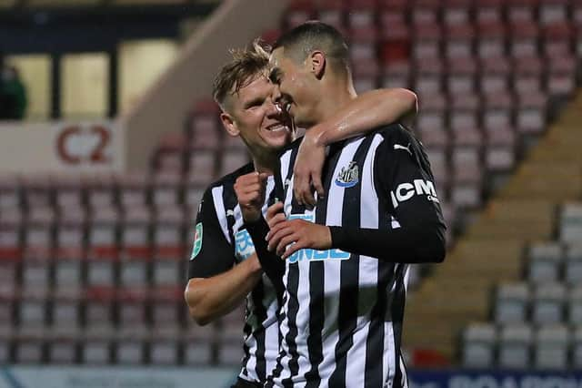 Miguel Almiron celebrates his goal against Morecambe with Matt Ritchie.