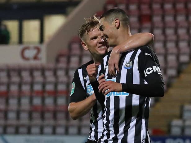 Miguel Almiron celebrates his goal against Morecambe with Matt Ritchie.
