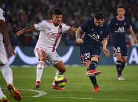 Paris Saint-Germain's Argentinian forward Lionel Messi (C) kicks the ball past Lyon's Brazilian midfielder Bruno Guimaraes during the French L1 football match between Paris-Saint Germain (PSG) and Olympique Lyonnais at The Parc des Princes Stadium in Paris on September 19, 2021. (Photo by FRANCK FIFE / AFP) (Photo by FRANCK FIFE/AFP via Getty Images)