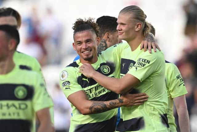 Manchester City's Norwegian striker Erling Haaland celebrates with Manchester City's English midfielder Kalvin Phillips (L) on the pitch after the English Premier League football match between West Ham United and Manchester City at the London Stadium, in London on August 7, 2022. (Photo by JUSTIN TALLIS/AFP via Getty Images)