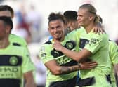 Manchester City's Norwegian striker Erling Haaland celebrates with Manchester City's English midfielder Kalvin Phillips (L) on the pitch after the English Premier League football match between West Ham United and Manchester City at the London Stadium, in London on August 7, 2022. (Photo by JUSTIN TALLIS/AFP via Getty Images)