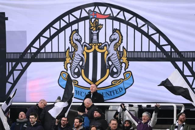 A flag showing the Tyne Bridge is pictured alongside fans in the Gallowgate End. (Photo by Stu Forster/Getty Images)