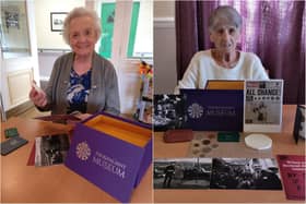 Willowdene Care Home residents Maureen Ingram, 86, (L) and Margaret Frith, 81, looking through the reminiscence box from The Royal Mint Museum.