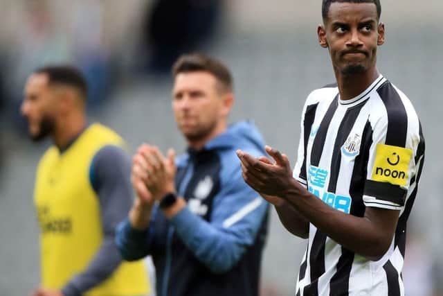 Newcastle United's Swedish striker Alexander Isak (R) applauds the fans following the English Premier League football match between Newcastle United and AFC Bournemouth at St James' Park in Newcastle-upon-Tyne, north east England on September 17, 2022.  (Photo by LINDSEY PARNABY/AFP via Getty Images)