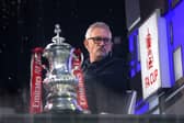 Gary Lineker sits in the BBC Studio next to the FA Cup
