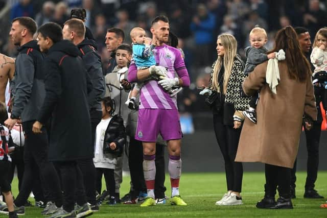 Newcastle United goalkeeper Martin Dubravka and family members of the players on the pitch after the Premier League match against Arsenal in May.