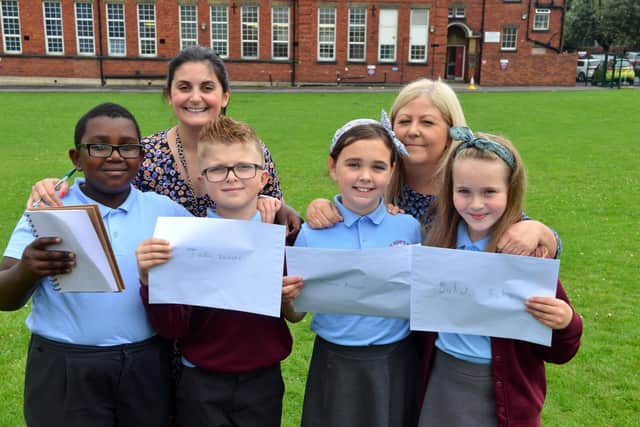 St Bede's Primary School children have sent personal letters to England player Marcus Rashford, Bukayo Saka and Jadon Sancho following racist abuse after the Euro 2020 final defeat. From left Ivan Murwisi, nine, Joshua Rixom, nine, Jessica Roberts, nine and Lainey Bradley, nine with teacher Jessica Romano and teaching assistant Sharon Hunt.