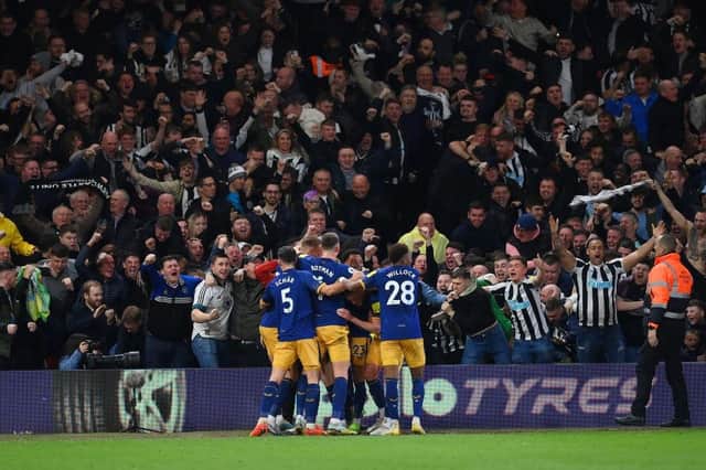 Elliot Anderson of Newcastle United celebrates with team mats after scoring the team's second goal during the Premier League match between Nottingham Forest and Newcastle United at City Ground on March 17, 2023 in Nottingham, England. (Photo by Shaun Botterill/Getty Images)