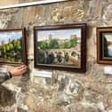 Picture perfect: Deryck Simpson placing his works in The Undercroft cafe at Durham Cathedral.