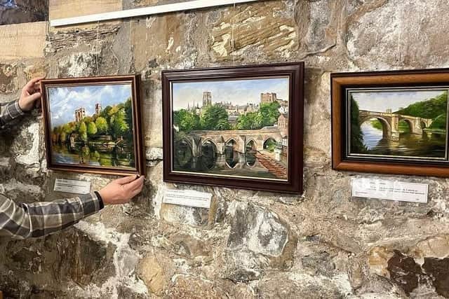 Picture perfect: Deryck Simpson placing his works in The Undercroft cafe at Durham Cathedral.