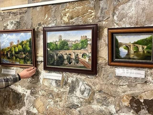 Picture perfect: Deryck Simpson placing his works in The Undercroft cafe at Durham Cathedral.
