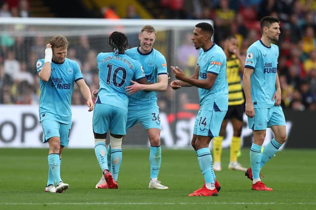 WATFORD, ENGLAND - SEPTEMBER 25: Sean Longstaff of Newcastle United celebrates scoring his sides first goal with Allan Saint-Maximin during the Premier League match between Watford and Newcastle United at Vicarage Road on September 25, 2021 in Watford, England. (Photo by Alex Morton/Getty Images)