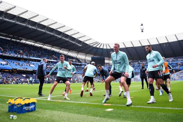 Newcastle United players warm up prior to the Premier League match between Manchester City and Newcastle United at Etihad Stadium on March 04, 2023 in Manchester, England. (Photo by Laurence Griffiths/Getty Images)
