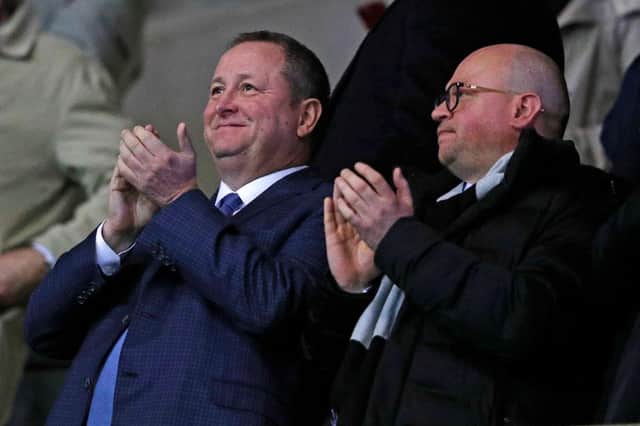 Newcastle United's English owner Mike Ashley (L) and director Lee Charnley (R) applaud after Newcastle take the lead during the FA Cup fourth round replay football match between Oxford United and Newcastle United at the Kassam Stadium in Oxford, west of London, on February 4, 2020.