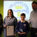 Annalise Allen, assistant head of pupil and staff wellbeing at Westoe Crown Primary School (left) alongside pupil and parents with the award.