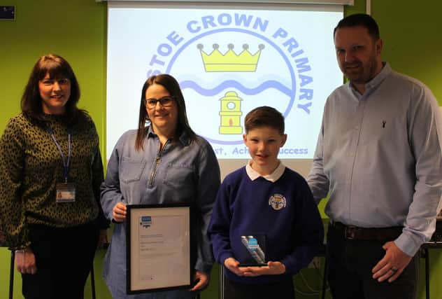 Annalise Allen, assistant head of pupil and staff wellbeing at Westoe Crown Primary School (left) alongside pupil and parents with the award.