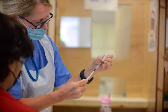 A healthcare worker prepares a covid vaccine