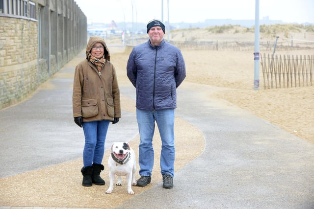 Clara and Tony Suggitt with dog Jason as they take a stroll at Sandhaven beach.