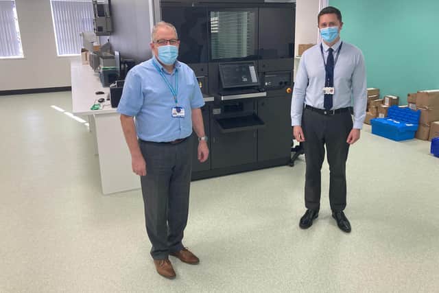 Chief Pharmacist Graeme Richardson and James Hubbard, Superintendent Pharmacist for CHoICE , in front of the control panel for the robot dispenser.