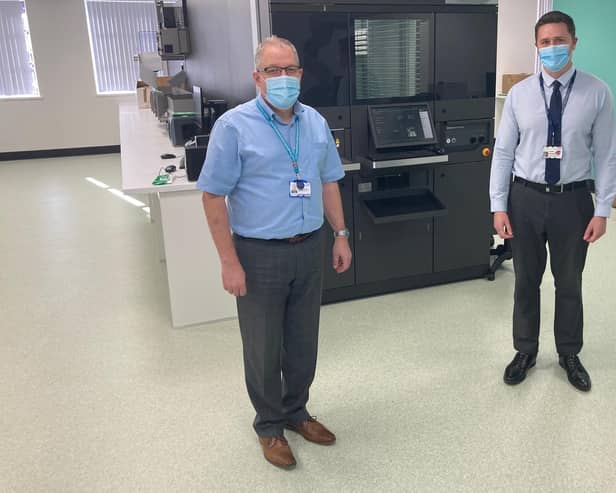 Chief Pharmacist Graeme Richardson and James Hubbard, Superintendent Pharmacist for CHoICE , in front of the control panel for the robot dispenser.