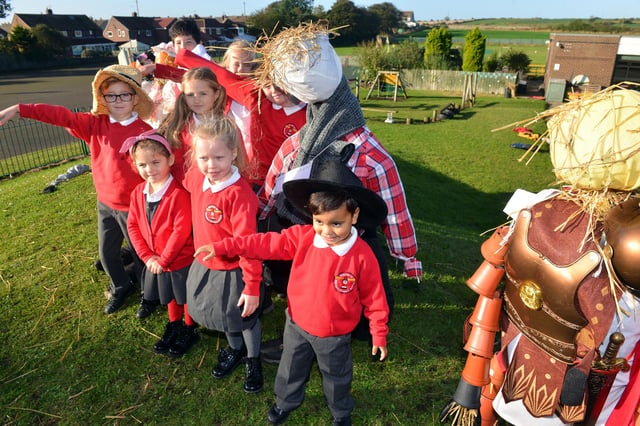 Marsden Primary School children impersonating some of the scarecrows they have made.