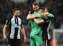 Newcastle United's Welsh defender Paul Dummett (L), Newcastle United's English defender Dan Burn (2nd L), Newcastle United's Slovakian goalkeeper Martin Dubravka (2nd R) and Newcastle United's Swiss defender Fabian Schar (R) celebrate on the pitch after the English Premier League football match between Newcastle United and Aston Villa at St James' Park in Newcastle-upon-Tyne, north east England on February 13, 2022. (Photo by OLI SCARFF/AFP via Getty Images)