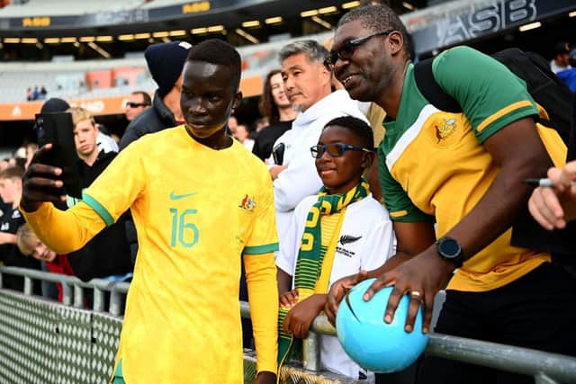 Newcastle United target Garang Kuol poses for a photo with Australia fans.