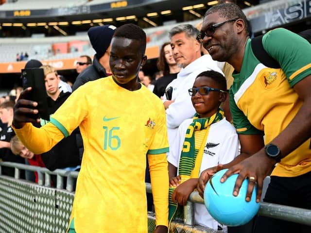 Newcastle United target Garang Kuol poses for a photo with Australia fans.