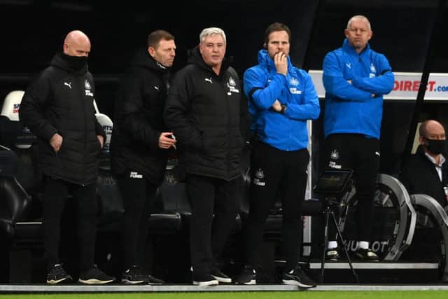 Steve Bruce, centre, looks on with his coaching team.