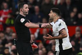 Fulham striker Aleksandar Mitrovic argues with referee Chris Kavanagh at Old Trafford.