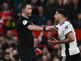 Fulham striker Aleksandar Mitrovic argues with referee Chris Kavanagh at Old Trafford.