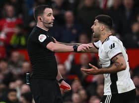 Fulham striker Aleksandar Mitrovic argues with referee Chris Kavanagh at Old Trafford.