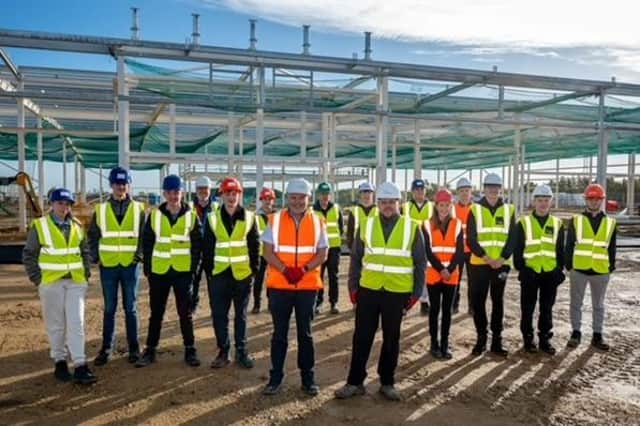 Castle site manager Aaron Robertson and John Cartwright of Hartlepool College on site with students.