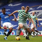 Alfredo Morelos of Rangers shoots under pressure from Kristoffer Ajer of Celtic during the Scottish Cup game between Rangers and Celtic at Ibrox Stadium on April 18, 2021 in Glasgow, Scotland.