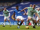 Alfredo Morelos of Rangers shoots under pressure from Kristoffer Ajer of Celtic during the Scottish Cup game between Rangers and Celtic at Ibrox Stadium on April 18, 2021 in Glasgow, Scotland.
