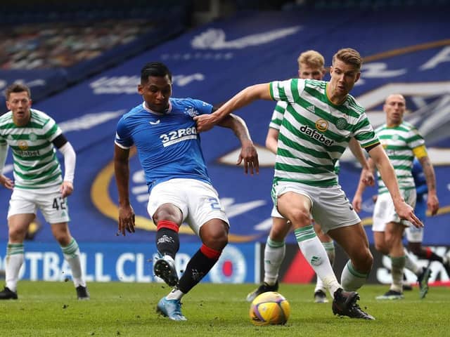 Alfredo Morelos of Rangers shoots under pressure from Kristoffer Ajer of Celtic during the Scottish Cup game between Rangers and Celtic at Ibrox Stadium on April 18, 2021 in Glasgow, Scotland.