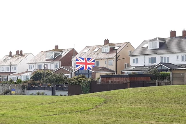 A flag in the rear garden of a house overlooking the seafront
