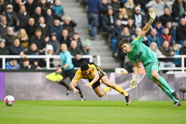 Newcastle United goalkeeper Nick Pope challenges Wolverhampton Wanderers' Raul Jimenez.