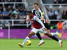 NEWCASTLE UPON TYNE, ENGLAND - OCTOBER 29: Leon Bailey of Aston Villa is challenged by Dan Burn of Newcastle United during the Premier League match between Newcastle United and Aston Villa at St. James Park on October 29, 2022 in Newcastle upon Tyne, England. (Photo by Nigel Roddis/Getty Images)
