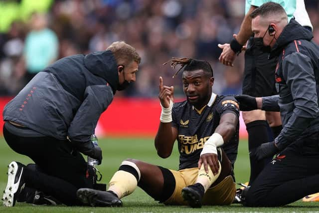 Newcastle United's Allan Saint-Maximin receives treatment against Tottenham Hotspur last season.