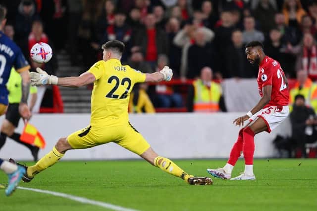 Emmanuel Dennis of Nottingham Forest scores the team's first goal past Nick Pope of Newcastle United during the Premier League match between Nottingham Forest and Newcastle United at City Ground on March 17, 2023 in Nottingham, England. (Photo by Laurence Griffiths/Getty Images)