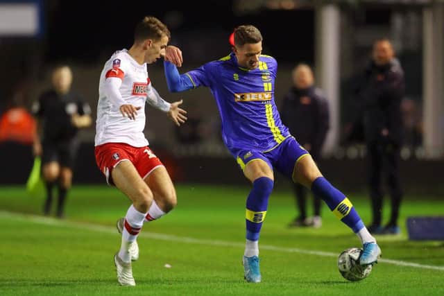 SOLIHULL, ENGLAND - DECEMBER 02: James Ball of Solihull Moors turns with the ball under pressure from Dan Barlaser of Rotherham United during the FA Cup Second Round match between Solihull Moors and Rotherham United at Damson Park on December 02, 2019 in Solihull, England. (Photo by Catherine Ivill/Getty Images)
