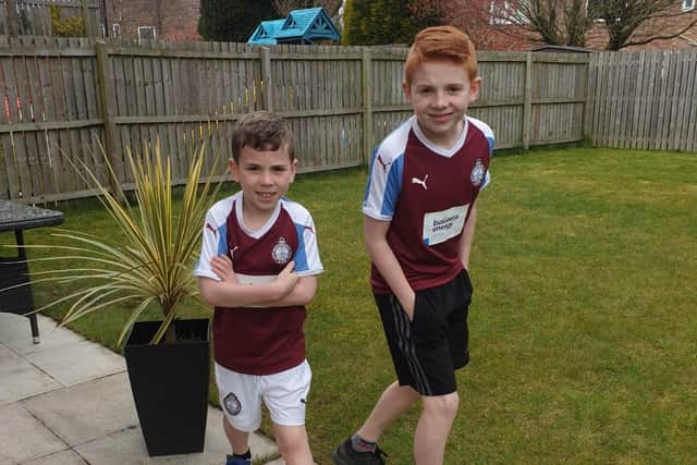 Charlie and Logan complete 22 laps wearing their South Shields Football Club kits.