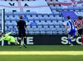 Lee Burge makes a save during Wigan Athletic's win at the DW Stadium