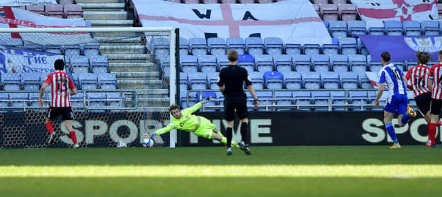 Lee Burge makes a save during Wigan Athletic's win at the DW Stadium