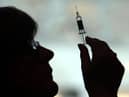 File photo of a nurse preparing to give a patient a vaccine.