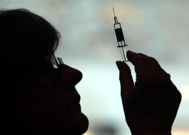 File photo of a nurse preparing to give a patient a vaccine.
